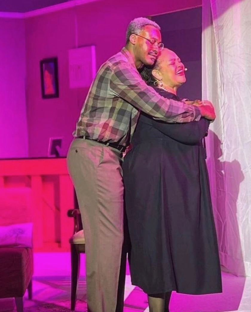 The Family Table — embrace between cast members